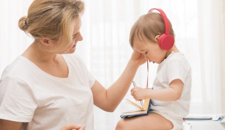 mid-shot-cute-baby-desk-with-headphones-mother