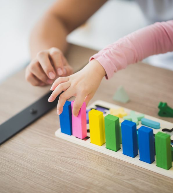 parent and girl playing Lego toddler brick blocks at home to improve life skill and education of preschool. Family leisure activity and communication